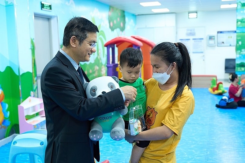 Ông Nguyễn Quang Trí – Giám đốc Điều hành Vinamilk, tặng quà cho các gia đình, các bé đến tiêm ngừa tại Trung tâm VNVC trong ngày ký kết hợp tác